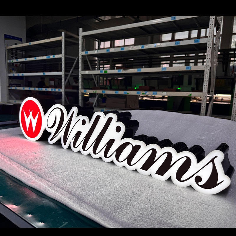Williams custom LED acrylic logo sign with black base structure and white script lettering